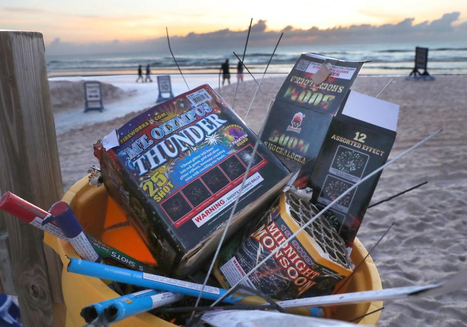 A trash can overflowing with used Roman candles tubes, sparkler wires and other fireworks packaging, Tuesday morning, July 5, 2022, as early morning beachgoers wait for the sunrise at The Granada Beach ramp.
