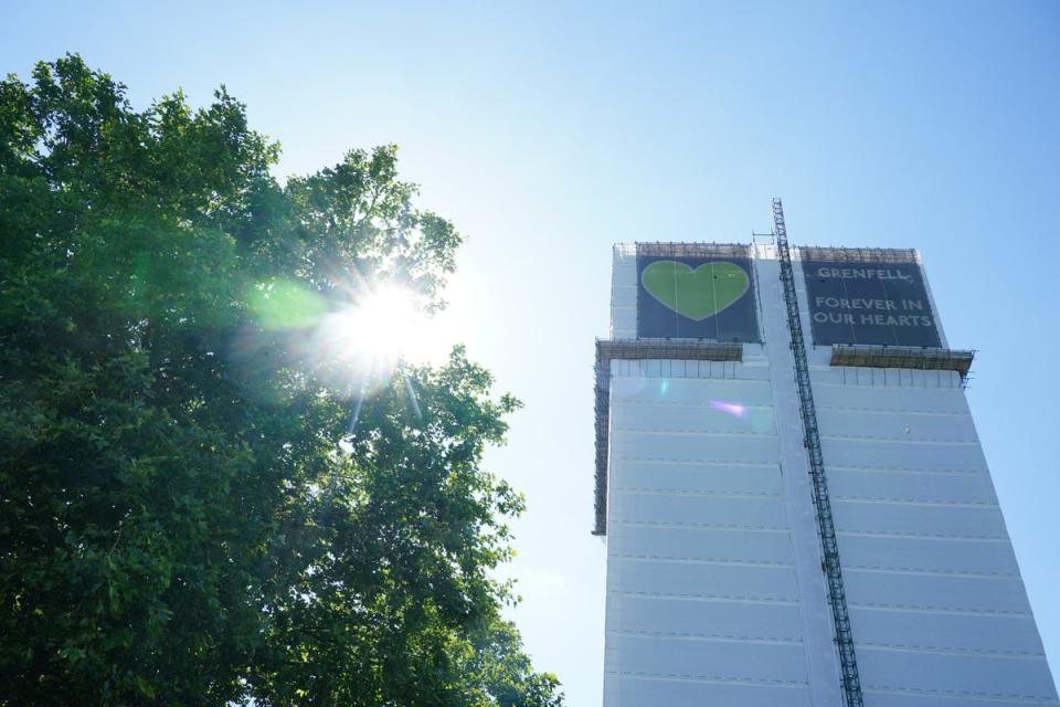 The remains of Grenfell Tower in London, its covering remembering those who died in the fire on June 14 2017 (Dominic Lipinski/PA) (PA Archive)