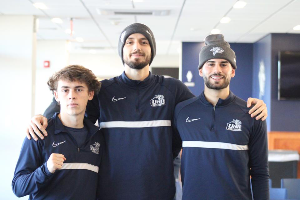 Taig Healy, left, Jassem Koilelat and Eli Goldman of the University of New Hampshire men's soccer team, gathered with teammates to watch the NCAA tournament selection show Monday, Nov. 14, 2022.