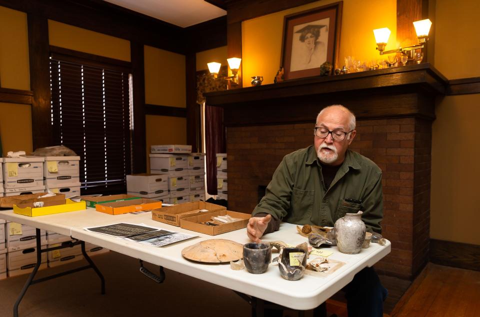 Director Floyd Mansberger of Fever River Research goes through some of the artifacts that have been unearthed during the dig of the 1908 Race Riot site at Fever River Research in Springfield, Ill., Friday, February 19, 2021. The items show the soot from the fires that destroyed forty black homes and 15 black-owned businesses during the 1908 Race Riot. [Justin L. Fowler/The State Journal-Register] 