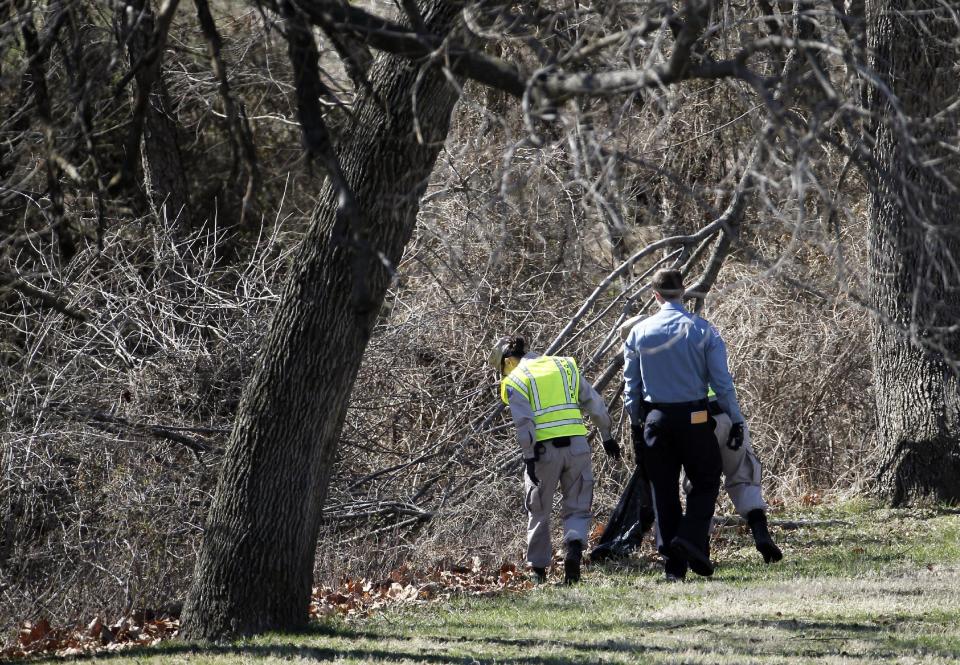 Washington Metro Police and cadets search in Kenilworth Park in Washington, Monday, March 31, 2014. Police have been searching the park in northeast Washington since last week for clues in the case of eight-year-old Relisha Rudd, last seen in the company of Kahlil Tatum, a janitor at the homeless shelter where she lived with her mother and brothers.(AP Photo/Alex Brandon)