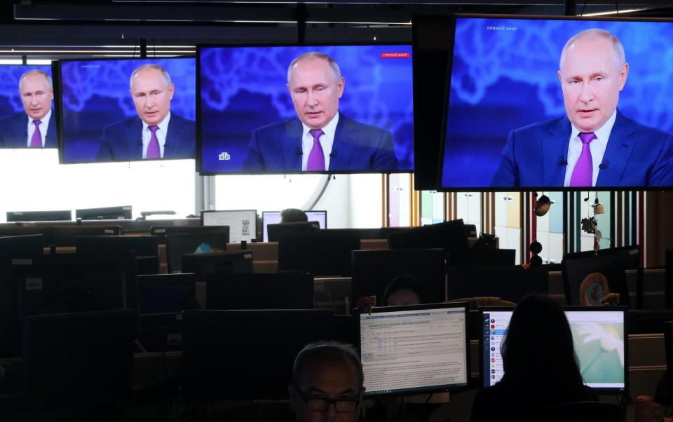 Russians watch a live broadcast of a question and answer session with President Putin - Gavriil Grigorov/TASS