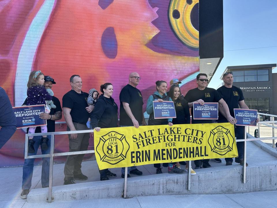 Salt Lake City Mayor Erin Mendenhall poses for a photo with firefighters who have endorsed her campaign for reelection Saturday at the Neighborhood Hive in Salt Lake City.
