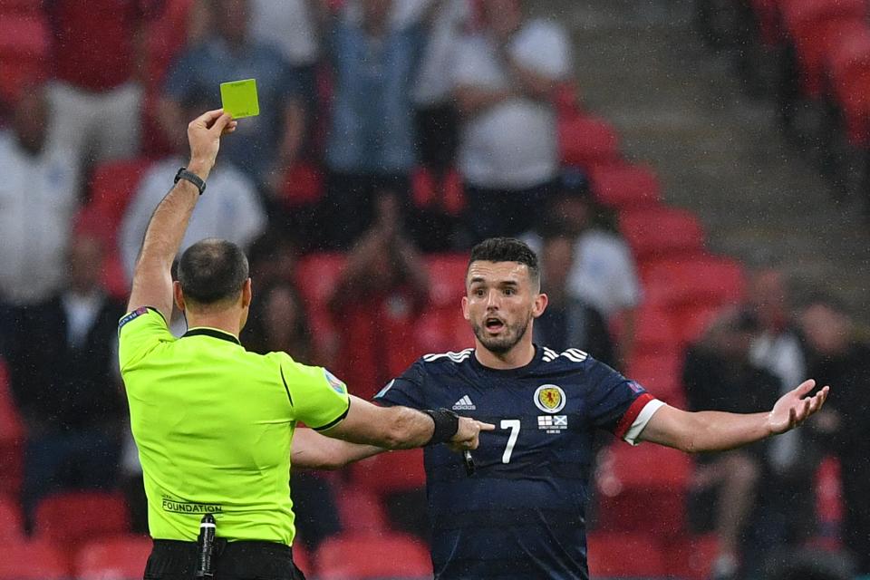 John McGinn is shown a yellow card (AFP/Getty)