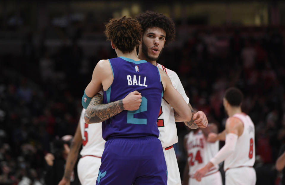 Chicago Bulls guard Lonzo Ball (2) hugs brother Charlotte Hornets guard LaMelo Ball (2) after a NBA basketball game Monday, Nov. 29, 2021 in Chicago. Chicago won 133-119. (AP Photo/Paul Beaty)