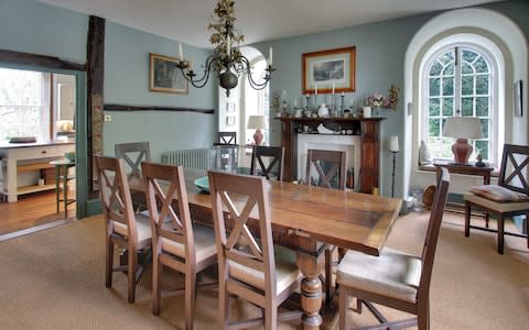 A dining room with a period fireplace 