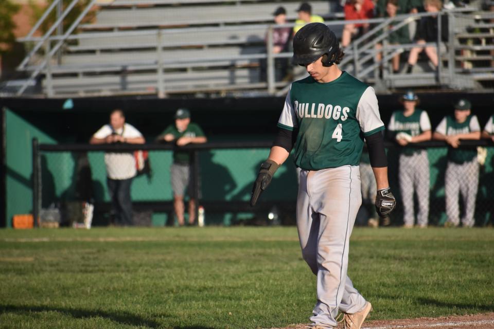 Senior Caleb Miller walks back to third base. The team captain pitched a complete game and drove in multiple runs