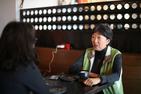 Angela Oh (R) talks to Grace Lee in a coffee shop in Koreatown, Los Angeles, California, April 27, 2018. REUTERS/Lucy Nicholson