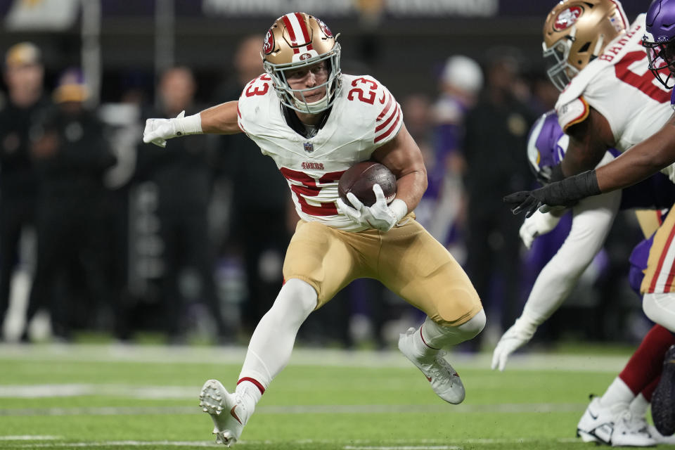 FILE - San Francisco 49ers running back Christian McCaffrey (23) runs with the football during the first half of an NFL football game against the Minnesota Vikings, Monday, Oct. 23, 2023, in Minneapolis. McCaffrey has been scoring at record-setting pace so far this season. That performance has helped the San Francisco 49ers star score the honor as being voted the top running back in the league by The Associated Press. (AP Photo/Abbie Parr, File)