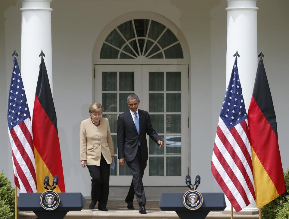 President Barack Obama and German Chancellor Angela Merkel arrive for their joint news conference in the Rose Garden of the White House in Washington, Friday, May 2, 2014. Obama and Merkel are putting on a display of trans-Atlantic unity against an assertive Russia, even as sanctions imposed by Western allies seem to be doing little to change Russian President Vladimir Putin's reasoning on Ukraine. (AP Photo/Charles Dharapak)