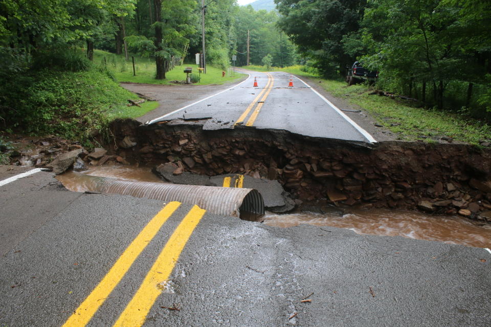 A road is washed out in the Harman area of Randolph County, W.V., Sunday, June 30, 2019. Severe thunderstorms caused flash flooding that knocked homes off their foundations and washed out roads in several mountainous counties of West Virginia, and some state lawmakers asked Gov. Jim Justice on Sunday to declare a state of emergency. (Destiny Judy/Daily Inter-Mountain via AP)