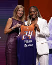 UCLA's Charisma Osborne, right, poses for a photo with WNBA commissioner Cathy Engelbert, left, after being selected 25th overall by the Phoenix Mercury during the third round of the WNBA basketball draft on Monday, April 15, 2024, in New York. (AP Photo/Adam Hunger)