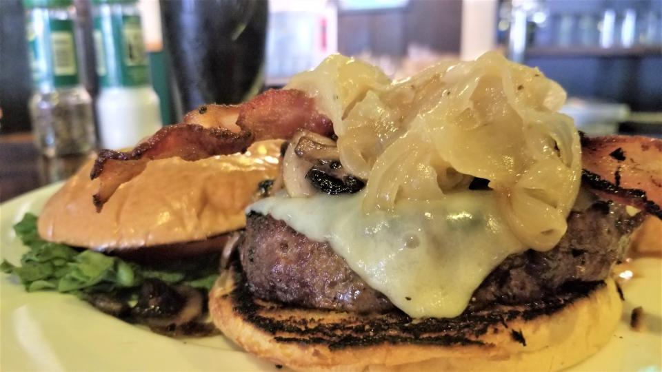 Our Pub Burger with bacon, braised onions, cheddar and sauteed mushroom at The Shebeen Irish Pub and Kitchen on Siesta Key photographed May 6, 2023.
