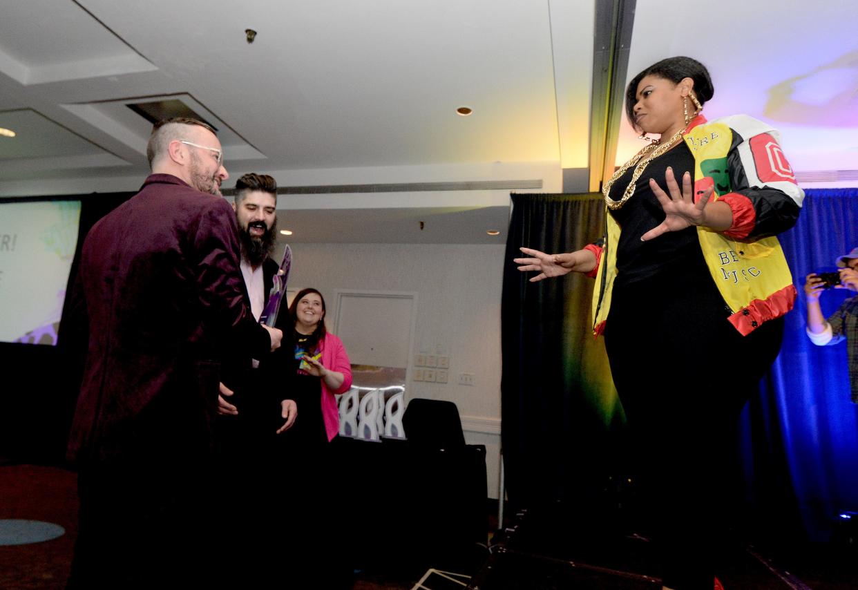 Owners of Clique, an LGBTQ bar in Springfield, Josh Delcour, left, and Justin Rebbe, center left, talk with Tonee Roper of Huff Media, right, after excepting their award for Best Night Life at the Downtown Springfield, Inc.'s 29th annual Dinner and Awards on April 6.