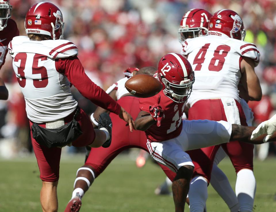 Nov 13, 2021; Tuscaloosa, Alabama, USA;  Alabama defensive back Terrion Arnold (12) blocks a punt by New Mexico State punter Josh Carlson (35) at Bryant-Denny Stadium. Mandatory Credit: Gary Cosby Jr.-USA TODAY Sports