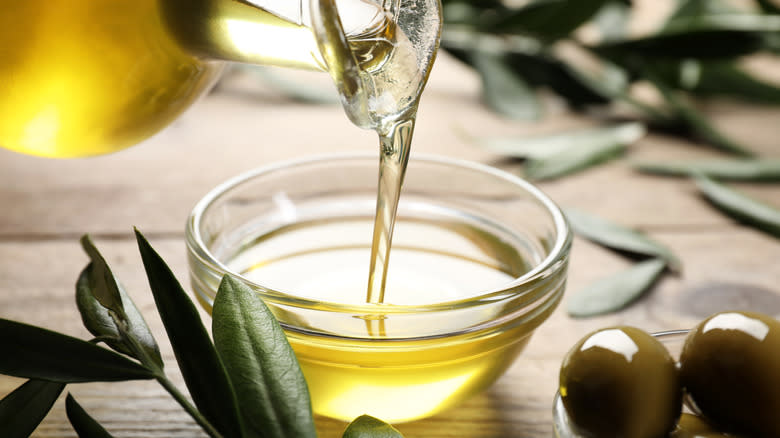 olive oil being poured into bowl