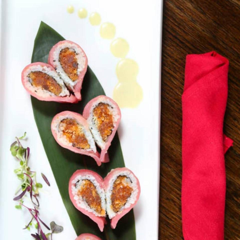 Coco Sushi Lounge & Bar's Valentine Roll is a heart-shaped sushi roll with tuna, salmon, masago, and avocado, topped with tuna.