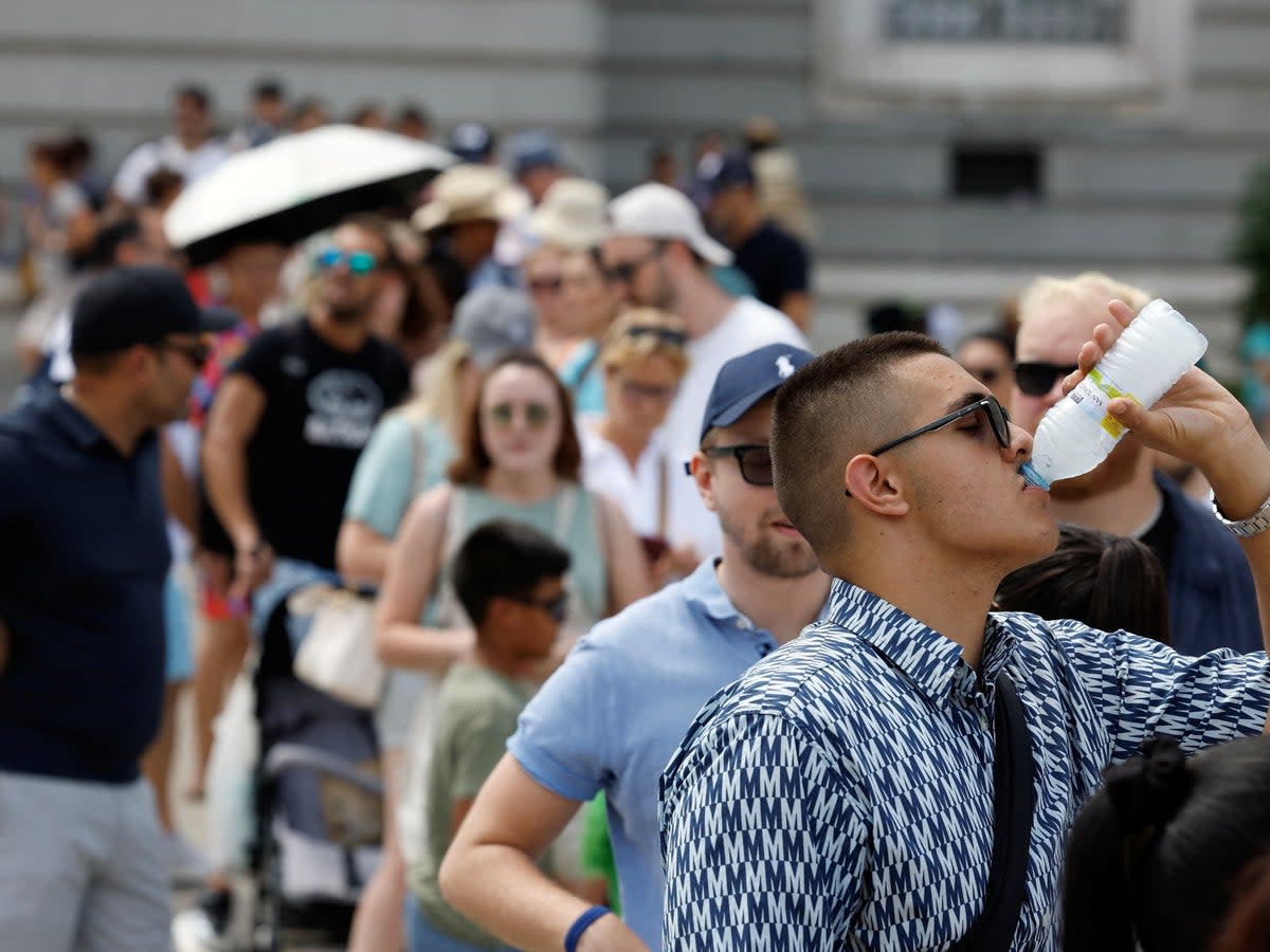 Tourists try to withstand the heat in Madrid as temperatures could soon lift well above 45C in parts of Spain (Juan Medina/Reuters)