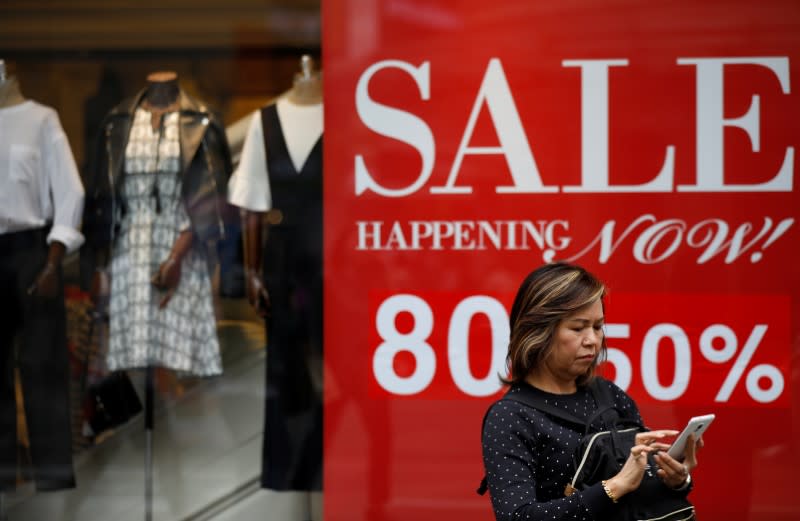 A woman looks at her mobile phone at the Myeongdong shopping district in Seoul