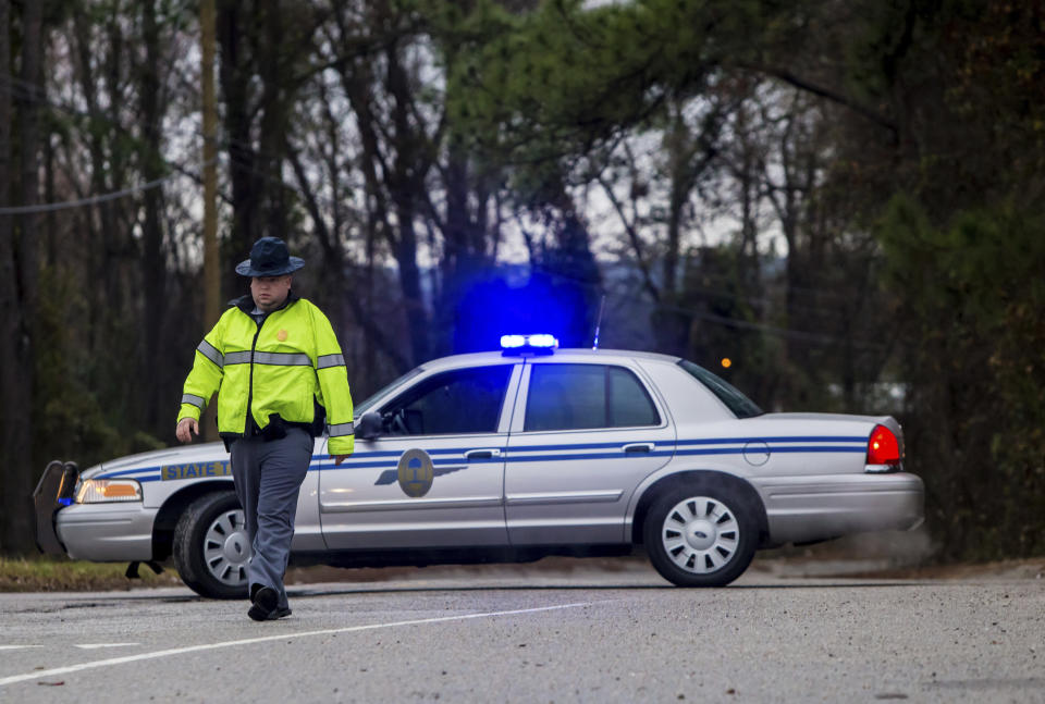 <p>A State Trooper directs people away from the site of an early morning train crash, Feb. 4, 2018, in Cayce, SC. (Photo: Jeff Blake/AP) </p>