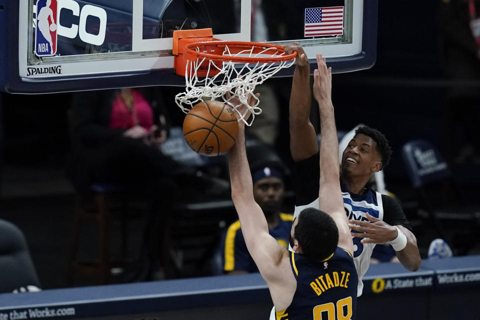 Minnesota Timberwolves' Jarrett Culver (23) dunks against Indiana Pacers' Goga Bitadze (88) during the second half of an NBA basketball game, Wednesday, April 7, 2021, in Indianapolis. (AP Photo/Darron Cummings)