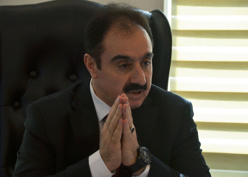 Mohamed Afif, the lawyer of former royal court chief Bassem Awadallah, speaks during an interview with Reuters in his office in Amman