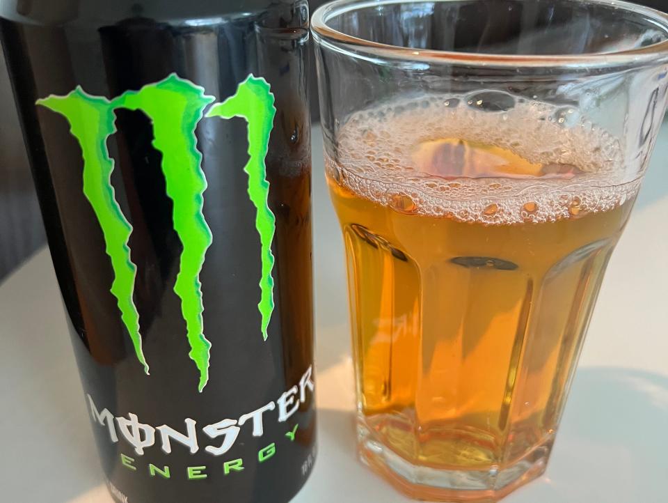 can of monster next to a glass of monster