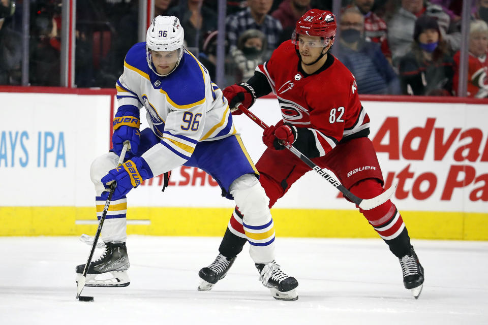 Buffalo Sabres' Anders Bjork (96) controls the puck in front of Carolina Hurricanes' Jesperi Kotkaniemi (82) during the second period of an NHL hockey game in Raleigh, N.C., Saturday, Dec. 4, 2021. (AP Photo/Karl B DeBlaker)