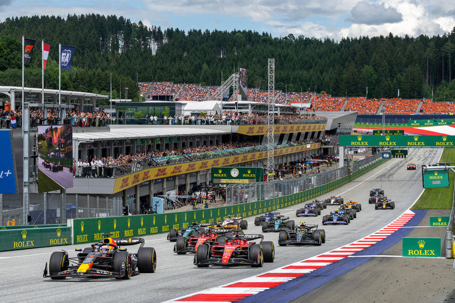 F1 cars approaching the first corner at the Red Bull Ring