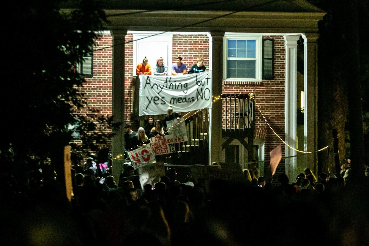 A banner at the Acacia fraternity house reads, "Anything but yes means no," during a protest Aug. 31 against the Phi Gamma Delta fraternity chapter at the University of Iowa. Protests at large public universities have spread across the country.