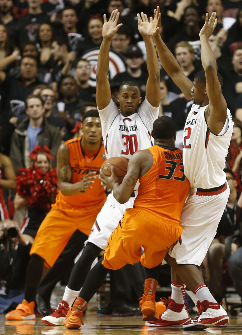 Texas Tech's Jaye Crockett(30) and Jordan Tolbert(32) defend Oklahoma State's Marcus Smart(33) during their NCAA college basketball game in Lubbock, Texas, Saturday, Feb, 8, 2014. (AP Photo/Lubbock Avalanche-Journal, Tori Eichberger) ALL LOCAL TV OUT