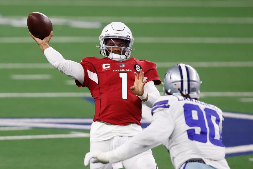 Arizona Cardinals quarterback Kyler Murray throws a pass while Dallas Cowboys defensive end DeMarcus Lawrence pressures in the second quarter of their 2020 game at AT&T Stadium.