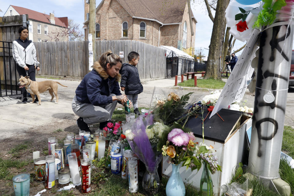 A resident lights a candle where  13-year-old Adam Toledo was shot by police in Chicago on April 16, 2021. / Credit: Shafkat Anowar / AP