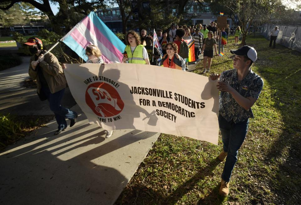 About 100 students supporting sexual minorities rallied on the lawn in front of the University of North Florida's Fine Arts Center Wednesday to protest the impending closure of the school's LGBTQ Center because of a state law banning university spending on diversity.
