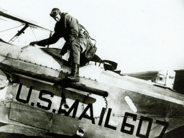 1926, Charles Lindberg flying in a DH-4 U.S. mail plane.