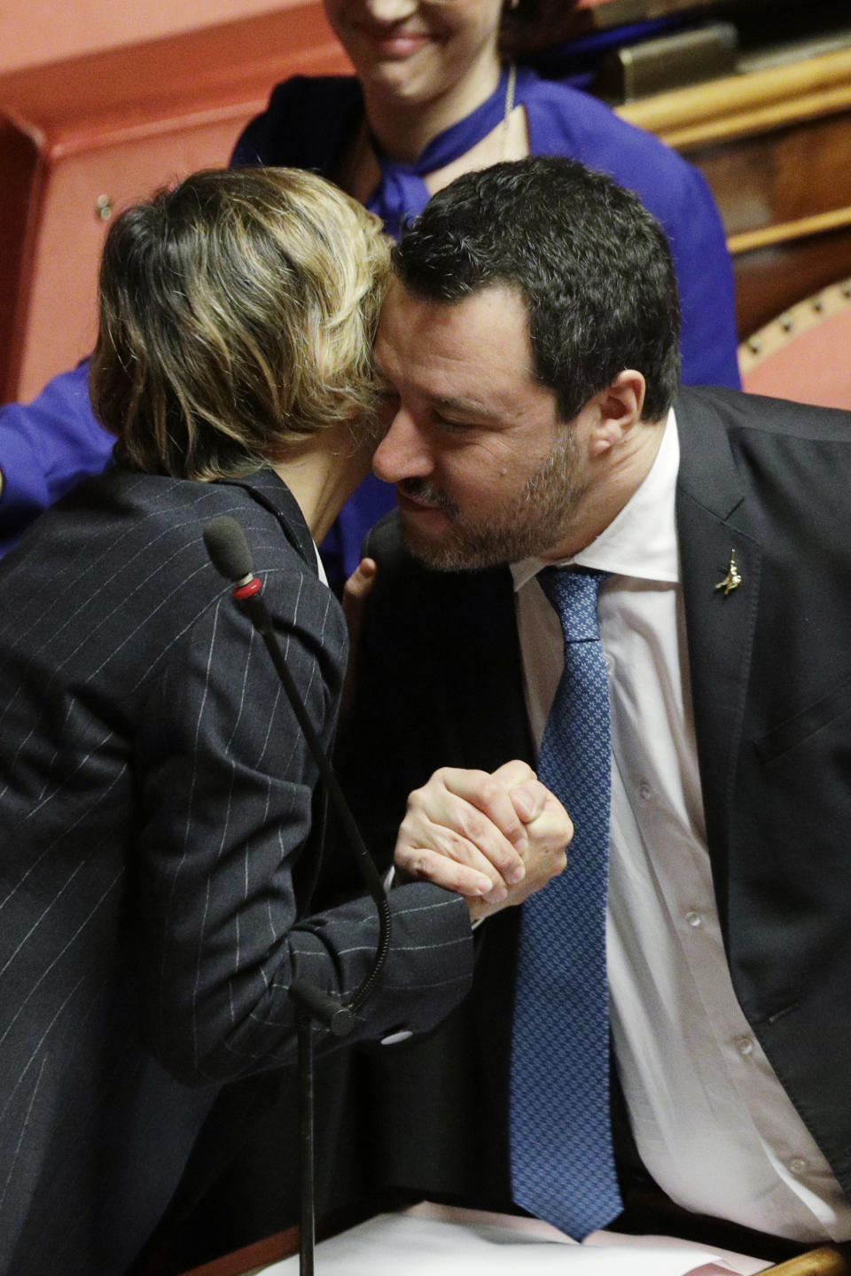 Opposition populist leader Matteo Salvini greets senator Giulia Bongiorno during the debate at the Italian Senate on whether to allow him to be prosecuted – as he demands to be -- for alleging holding migrants hostage for days aboard coast guard ship Gregoretti instead of letting them immediately disembark in Sicily, while he was interior minister. Salvini says being on trial for alleged kidnapping is tantamount to defending his country from illegal migrants he blames for crime and for subtracting jobs from Italians. (AP Photo/Andrew Medichini)