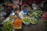 A vegetable seller takes rest at a wholesale vegetable market in Guwahati, India, Wednesday, Feb. 1, 2023. Indian Prime Minister Narendra Modi's government ramped up capital spending by a substantial 33% to $122 billion in an annual budget presented to Parliament on Wednesday, seeking to spur economic growth and create jobs ahead of a general election next year. (AP Photo/Anupam Nath)
