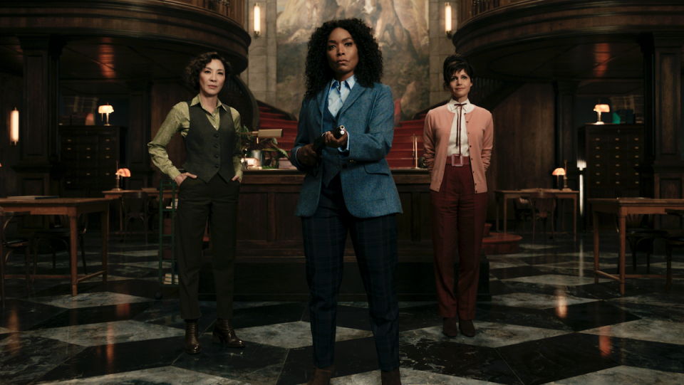 Michelle Yeoh, Angela Bassett, and Carla Gugino stand in a fancy room.