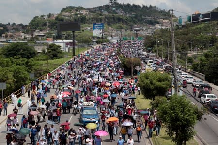 Demonstrators march against President Juan Orlando Hernandez government's plans to privatize healthcare and education, in Tegucigalpa