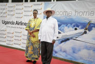 FILE - In this Tuesday, April 23, 2019 file photo, Uganda's President Yoweri Museveni and First Lady Janet Museveni attend a ceremony to mark the arrival of two CRJ-900 jets from Canadian aerospace company Bombardier for Uganda's national carrier Uganda Airlines, at the airport in Entebbe, Uganda. Questions are swirling in Africa and elsewhere over the financial wisdom of sustaining prestige carriers that have a tiny share of an aviation market that sees no recovery in sight as sub-Saharan Africa faces its first recession in a quarter-century amid coronavirus-related travel restrictions. (AP Photo/Ronald Kabuubi, File)