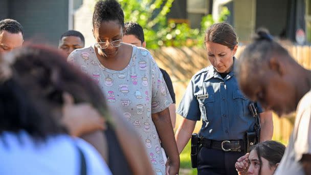 PHOTO: Kansas City Police Chief Stacey Graves held hands with Cherron Barney, left, and another woman as people gathered in the street to pray following a shooting , June 25, 2023, in Kansas City. (Tammy Ljungblad/The Kansas City Star/TNS via Newscom)