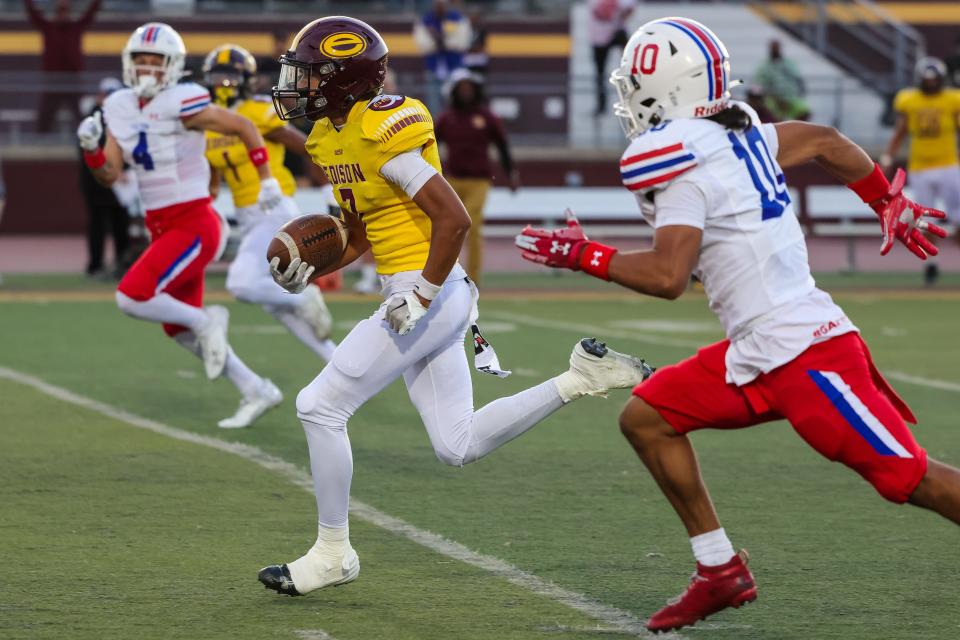 Edison wide receiver Isaac Sagapolu speeds past the defense on his way to an early touchdown in a game between Folsom High and Edison High School in Stockton Friday night