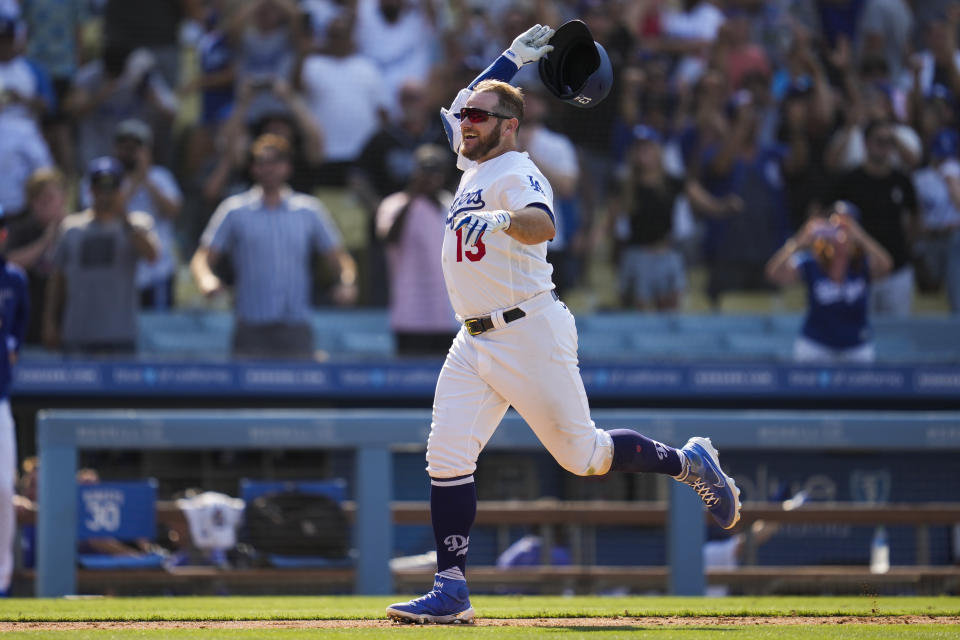 Los Angeles Dodgers' Max Muncy (13) runs the bases after hitting a home run during the ninth inning of a baseball game against the Arizona Diamondbacks Sunday, July 11, 2021, in Los Angeles. Zach Reks and Mookie Betts also scored. The homer won the game for the Dodgers 7-4. (AP Photo/Ashley Landis)