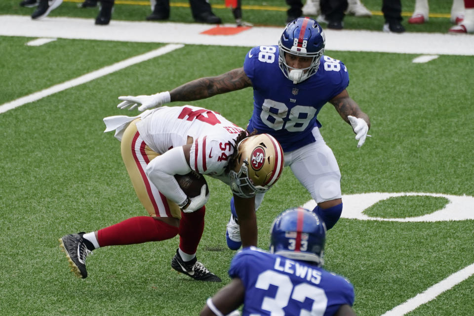 San Francisco 49ers' Fred Warner, left, intercepts a ball thrown by New York Giants quarterback Daniel Jones during the first half of an NFL football game, Sunday, Sept. 27, 2020, in East Rutherford, N.J. (AP Photo/Corey Sipkin)