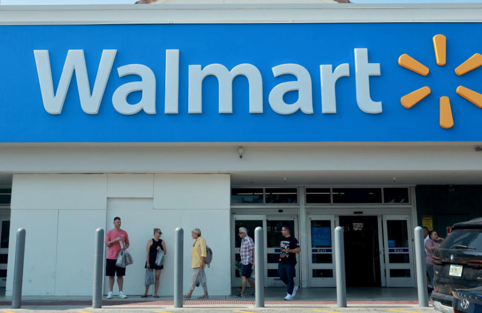 People walking outside a Walmart store