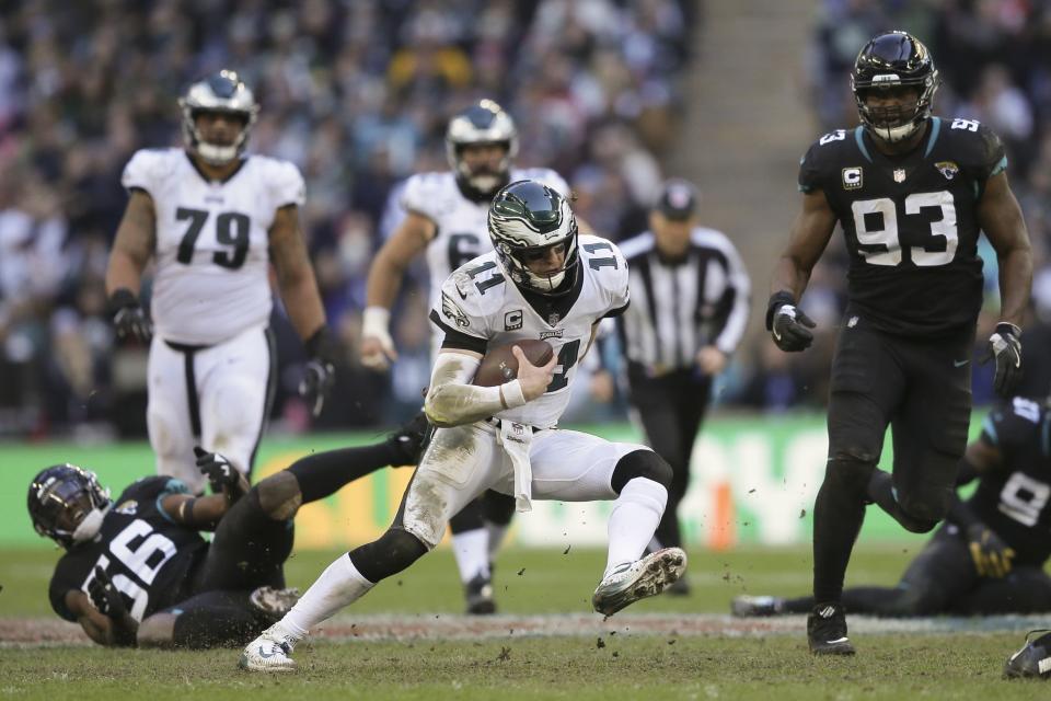 Philadelphia Eagles quarterback Carson Wentz (11) scrambles during the first half of an NFL football game against Jacksonville Jaguars at Wembley stadium in London, Sunday, Oct. 28, 2018. (AP Photo/Tim Ireland)