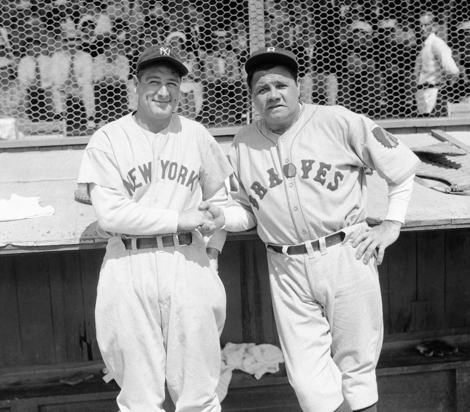 Former New York Yankees teammates Babe Ruth, right, and Lou Gehrig pose together at a spring training game in St. Petersburg, Fla., in 1935 as they met for the first time after Ruth left the Yankees for the Boston Braves.