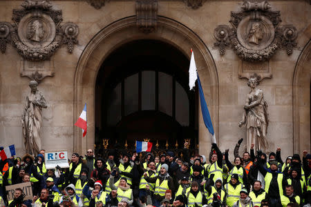 Protesters wearing yellow vests gather in front of the Opera House as part of the "yellow vests" movement in Paris, France, December 15, 2018. REUTERS/Christian Hartmann