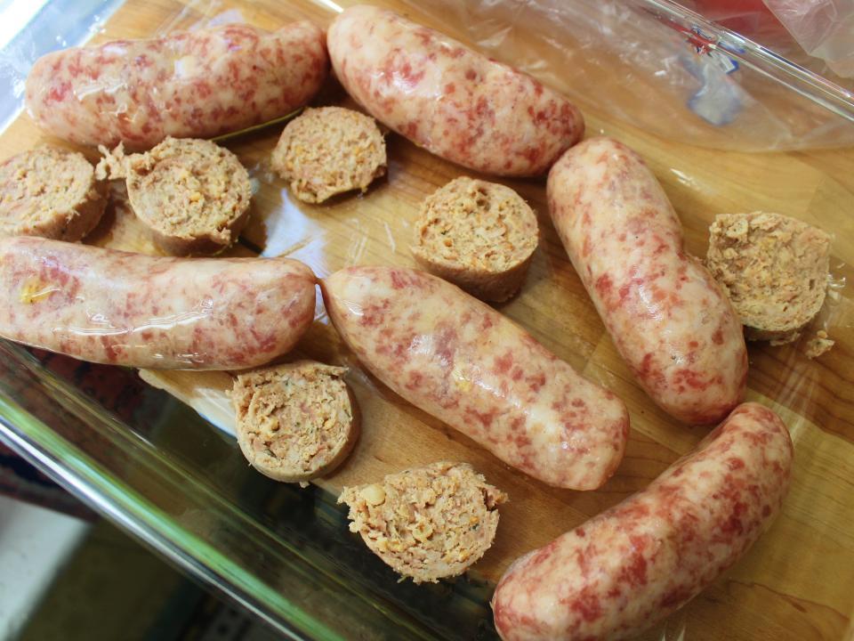 white pudding and sausages in a glass baking pan