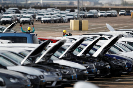 Greenpeace activists walk in the vehicle park after they gained access to protest against Volkswagen diesel vehicles at the port of Sheerness, Britain, September 21, 2017. REUTERS/Peter Nicholls